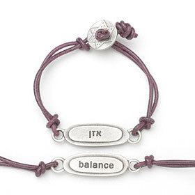This bracelet has a pewter charm on colored leather with the word 