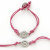 This bracelet has a pewter charm on colored leather with the word 